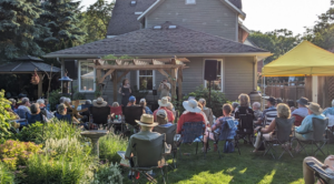 A group of people watching outside theatre show.